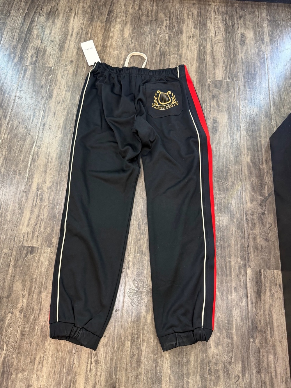 Gucci Black Joggers with Red Side Stripe and Gold Crest